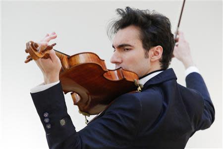 Violist David Aaron Carpenter of the U.S. plays the 'Macdonald' Viola by Antonio Stradivari, made in 1719, at Sotheby's gallery in New York March 27, 2014. REUTERS/Eduardo Munoz