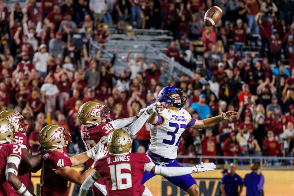 Florida State's Ja'Bril Rawls (30) and North Alabama kicker Sam Contorno (37) pursue a blocked kick that Florida State recovered and ran back for the final touchdown off an NCAA college football game Saturday, Nov. 18, 2023, in Tallahassee, Fla. (AP Photo/Colin Hackley)