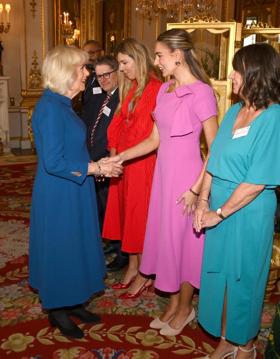 The Queen meets Zara McDermott at a palace reception for the Wash Bags Project (AP)