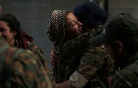 Syria Democratic Forces (SDF) female fighters embrace each other in the city of Manbij, in Aleppo Governorate, Syria, August 10, 2016. REUTERS/Rodi Said