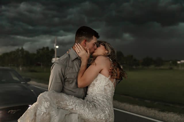 <p>Ashley Patton Photography LLC, midwest</p> Trapper and MaKayla Shore kiss while posing for wedding photos