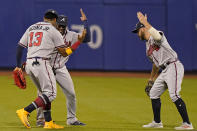 Atlanta Braves right fielder Ronald Acuña Jr. (13) celebrates with left fielder Guillermo Heredia, center, and center fielder Ender Inciarte after their victory over the New York Mets in the second baseball game of a doubleheader, Monday, June 21, 2021, in New York. (AP Photo/Kathy Willens)