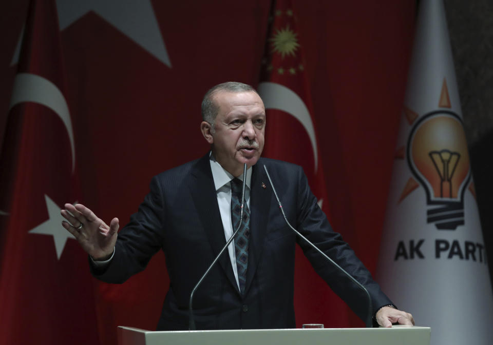 Turkey's President Recep Tayyip Erdogan speaks to his ruling party officials, in Ankara, Turkey, Thursday, Oct. 10, 2019. Erdogan says that there have been 109 "terrorists killed" — a reference to Syrian Kurdish fighters — since Ankara launched an offensive into Syria the previous day. Erdogan also warned the European Union not to call Ankara's incursion into Syria an 'invasion,' and renewed his threat of letting Syrian refugees flood Europe. (Turkish Presidency Press Service via AP, Pool)