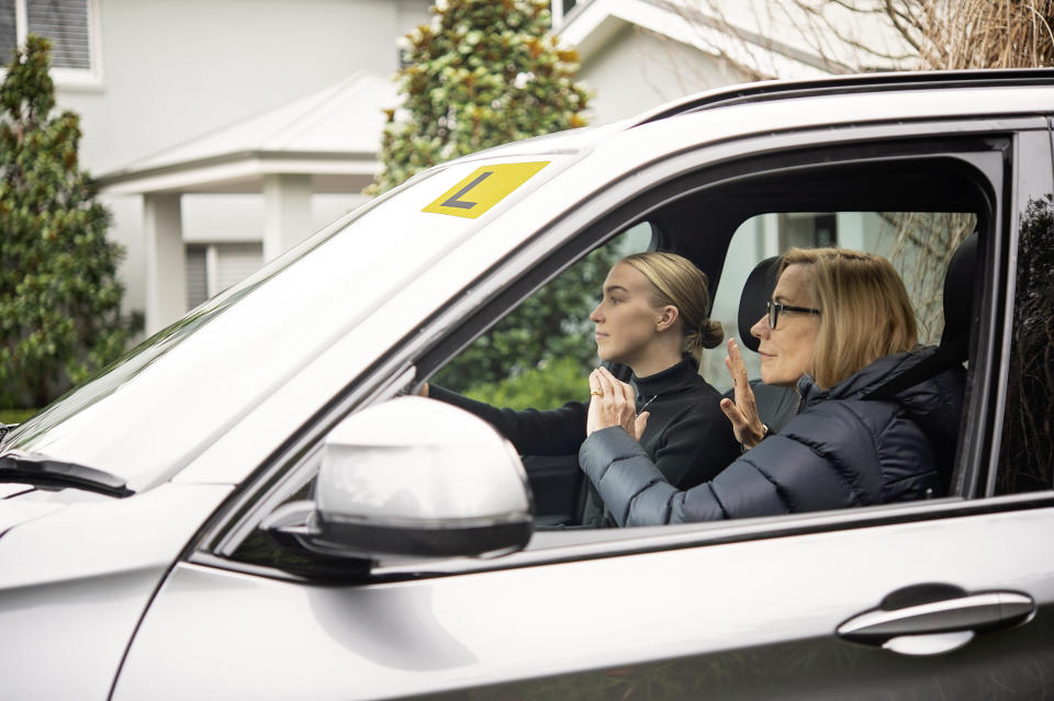 Two women driving in a car.