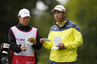 Hideki Matsuyama, right, of Japan, prepares to hit from the 15th tee of the Silverado Resort North Course during the final round of the Fortinet Championship PGA golf tournament in Napa, Calif., Sunday, Sept. 18, 2022. (AP Photo/Eric Risberg)