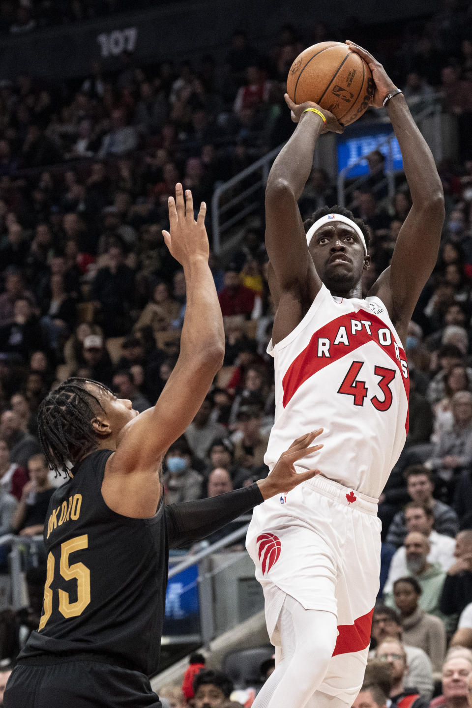 Toronto Raptors' Pascal Siakam (43) shoots on Cleveland Cavaliers' Isaiah Mobley during the first half of an NBA basketball game in Toronto, Monday, Nov. 28, 2022. (Chris Young/The Canadian Press via AP)