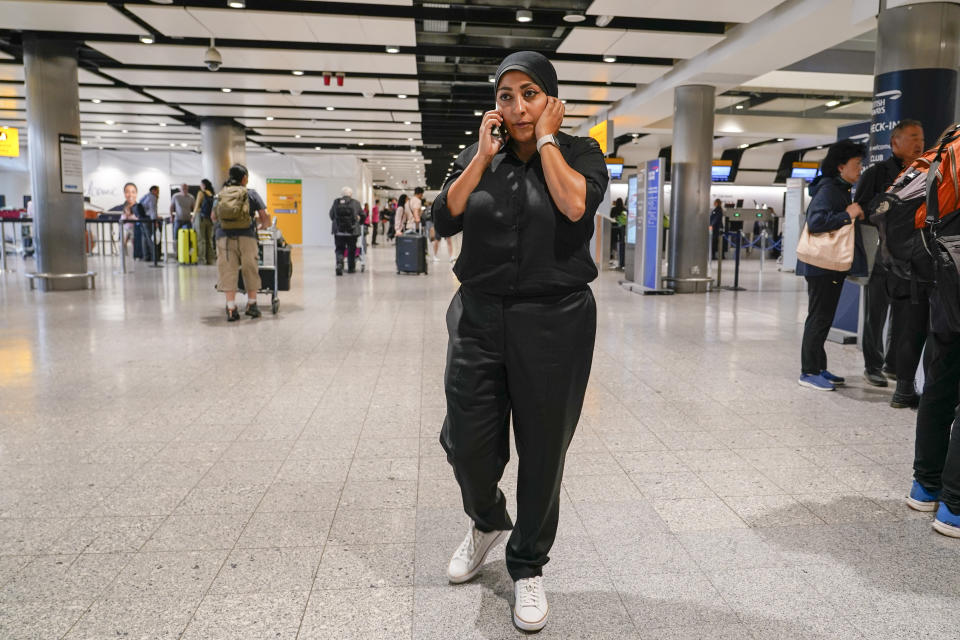 Maryam al-Khawaja speaks at the phone at Heathrow airport, in London, Friday, Sept. 15, 2023, as the daughter of the long-detained human rights activist in Bahrain, 62-year-old Abdulhadi al-Khawaja, plans to return to the island kingdom Friday to press for the release of her father, even as she faces imprisonment herself. (AP Photo/Alberto Pezzali)