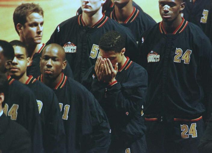 <span class="caption">Mahmoud Abdul-Rauf bows his head in prayer during the singing of the national anthem.</span> <span class="attribution"><a class="link " href="https://www.gettyimages.com/detail/news-photo/denver-nuggets-guard-mahmoud-abdul-rauf-bows-his-head-in-news-photo/51975529?adppopup=true" rel="nofollow noopener" target="_blank" data-ylk="slk:Eric Chu/AFP via Getty Images">Eric Chu/AFP via Getty Images</a></span>