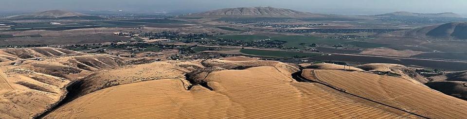 This panoramic view looks northeast off Badger Canyon Road shows Badger Mountain, Benton City and towards West Richland through the saddle of Badger and Candy Mountains, at right..