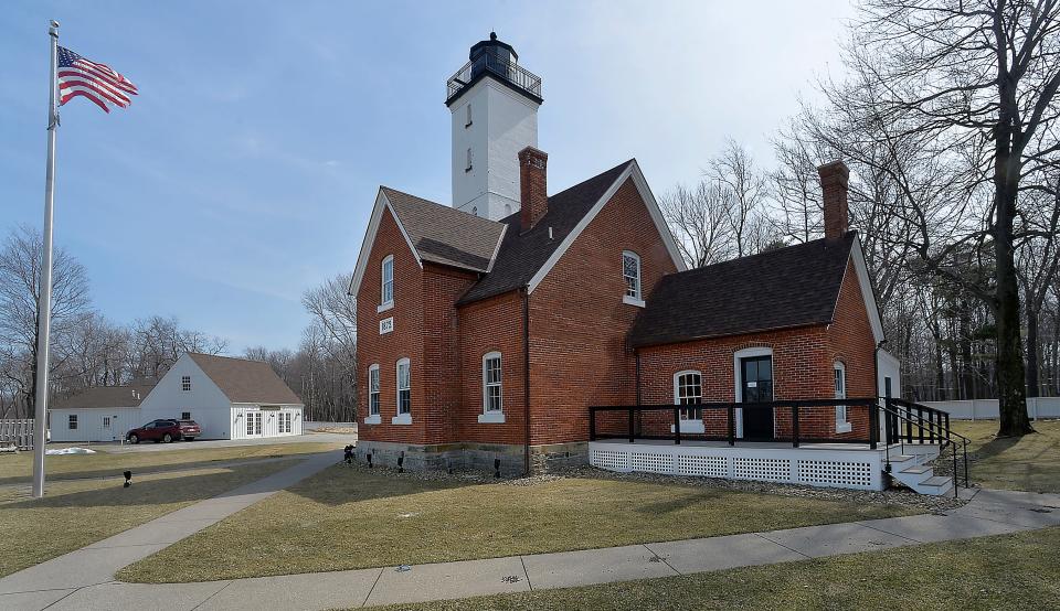 The brick tower of the Presque Isle Lighthouse was completed in 1873 and was initially 40 feet high but an additional 17 feet was added in 1896. While the exterior of the tower is square, the interior is circular with 78 spiral steps and six landings. The attached dwelling previously housed lighthouse keepers and their families.