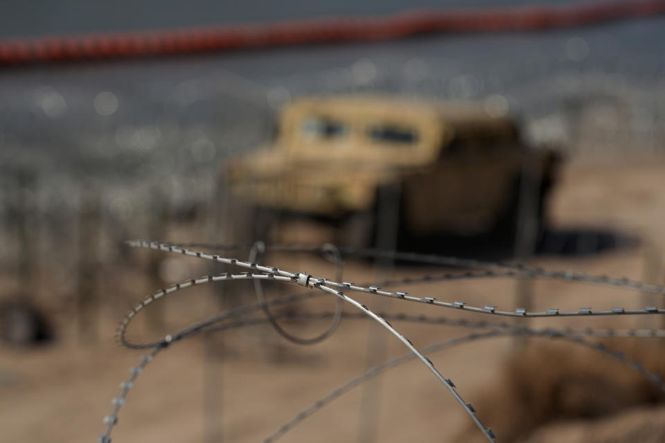 Concertina wire is seen in the foreground of the Rio Grande, Thursday, Feb. 1, 2024, in Eagle Pass, Texas. The Texas border city has gained an unsolicited spotlight in an extraordinary showdown between the state's Republican governor and Democratic White House over border security. (AP Photo/Eric Gay)