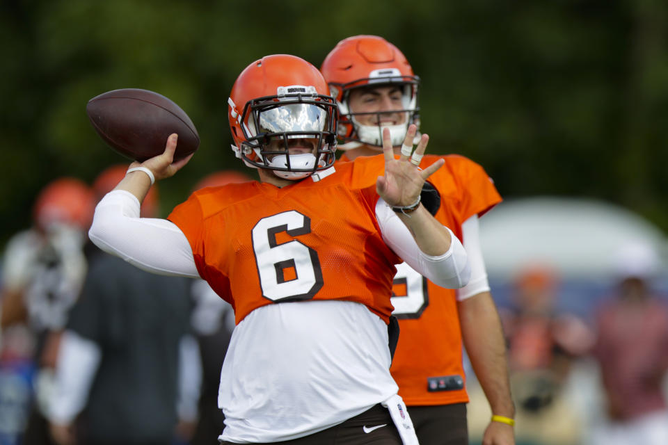 Cleveland Browns quarterback Baker Mayfield (6) throws in front of quarterback David Blough (9) during practice at the NFL team's football training camp in Westfield, Ind., Thursday, Aug. 15, 2019. The Browns held a joint practice with the Indianapolis Colts. (AP Photo/Michael Conroy)