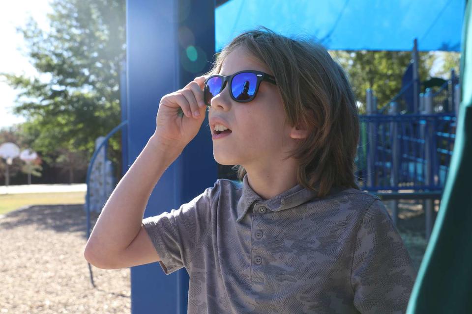 <p>Grapvine-Collyeville ISD</p> Jaron Casillas, 10, a color blind student, tries on his special glasses that were paid for by his classmates