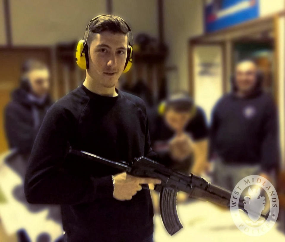 Mark Jones, posing with an assault rifle.