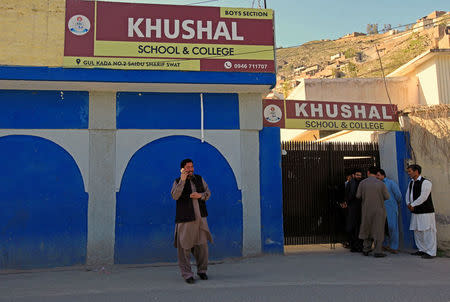 A man talks on his phone outside Khushal school that Nobel Peace Prize laureate Malala Yousafzai used to attend, in her hometown of Mingora in Swat Valley, Pakistan March 30, 2018. REUTERS/Faisal Mahmood