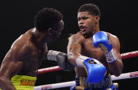 Jeremiah Nakathila, of Namibia, left, fights Shakur Stevenson in a WBO interim junior lightweight title fight Saturday, June 12, 2021, in Las Vegas. (AP Photo/John Locher)