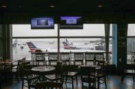 Empty chairs are seen at a restaurant in the central terminal of LaGuardia Airport in the Queens borough of New York April 8, 2014. REUTERS/Shannon Stapleton