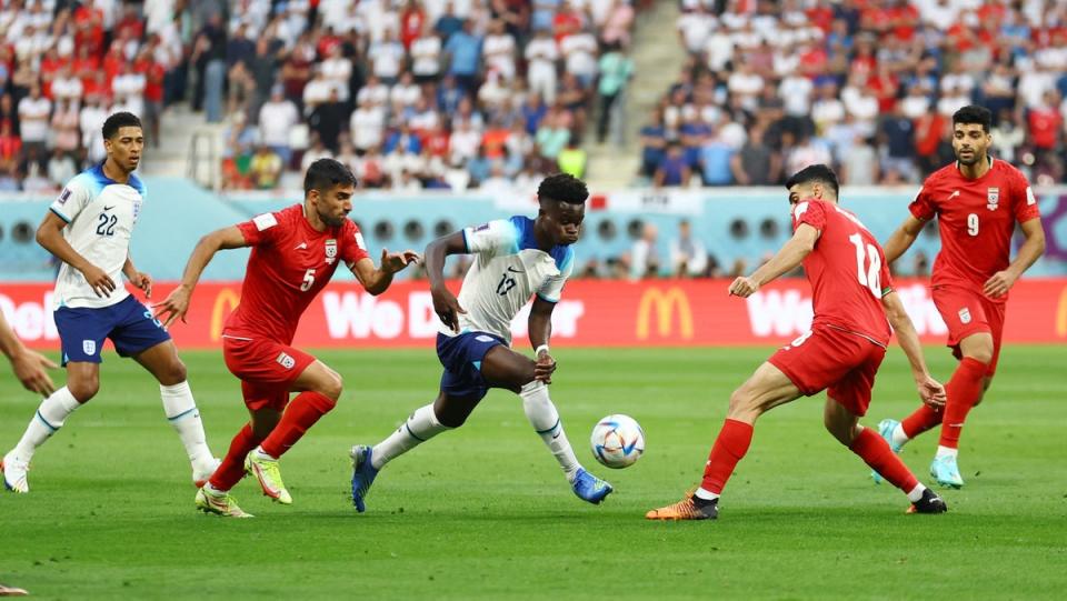 England’s Bukayo Saka in action with Iran’s Ali Karimi and Milad Mohammadi (REUTERS)