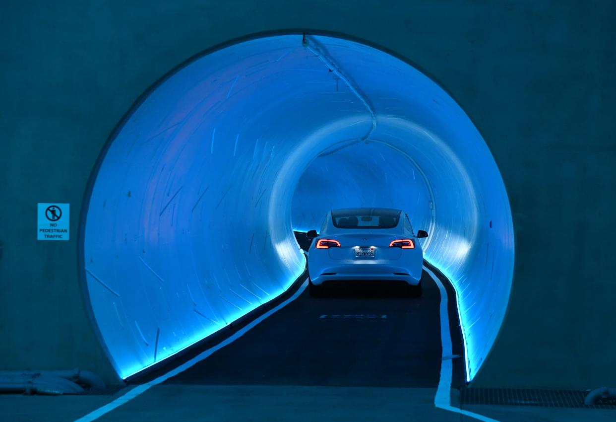 Tesla car drives through a tunnel in the Central Station during a media preview of the Las Vegas Convention Center Loop on April 9, 2021 in Las Vegas, Nevada.