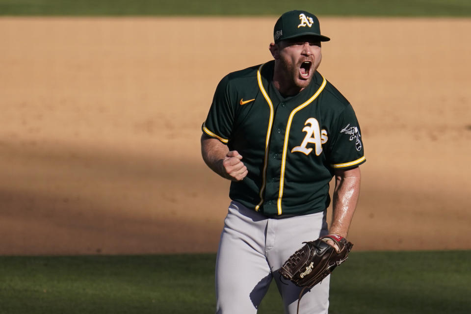 Oakland Athletics pitcher Liam Hendriks reacts after the Athletics defeated the Houston Astros in Game 3 of a baseball American League Division Series against the Houston Astros in Los Angeles, Wednesday, Oct. 7, 2020. (AP Photo/Marcio Jose Sanchez)