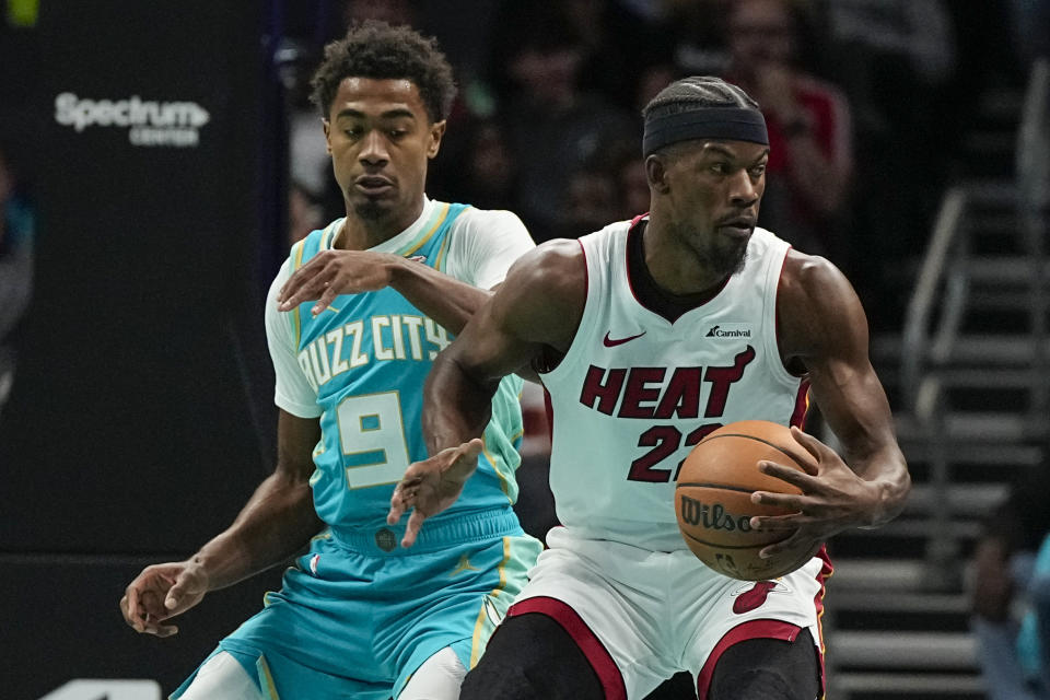 Miami Heat forward Jimmy Butler drives to the basket past Charlotte Hornets guard Theo Maledon during the first half of an NBA basketball game on Tuesday, Nov. 14, 2023, in Charlotte, N.C. (AP Photo/Chris Carlson)