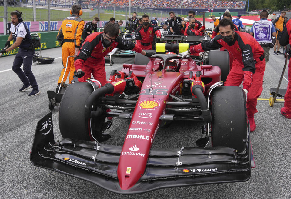 Mechanics push car of Ferrari driver Charles Leclerc of Monaco prior the Sprint Race qualifying session at the Red Bull Ring racetrack in Spielberg, Austria, Saturday, July 9, 2022. The Austrian F1 Grand Prix will be held on Sunday July 10, 2022. (AP Photo/Matthias Schrader)