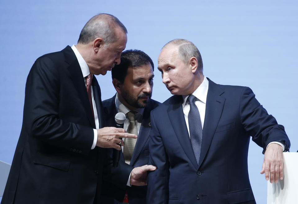 Russian President Vladimir Putin, right, listens to Turkey's President Recep Tayyip Erdogan through an interpreter, as they attend an event marking the completion of one of the phases of the Turkish Stream natural gas pipeline, in Istanbul, Monday, Nov. 19, 2018. (AP Photo/Lefteris Pitarakis)