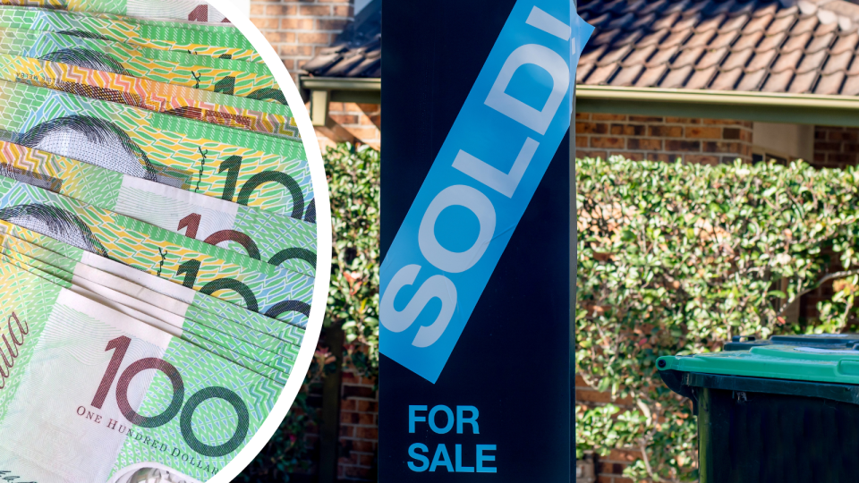 Australian $100 notes stacked on top of each other and a sold sign on a property.