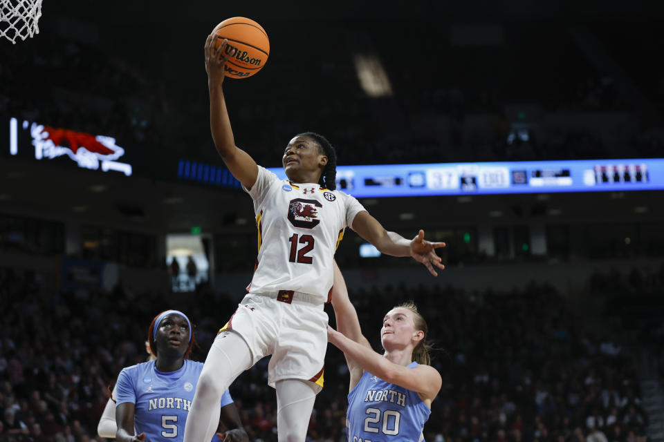 South Carolina guard MiLaysia Fulwiley (12) drives to the basket ahead of North Carolina forward Maria Gakdeng (5) and guard Lexi Donarski (20) during the second half of a second-round college basketball game in the women's NCAA Tournament in Columbia, S.C., Sunday, March 24, 2024. (AP Photo/Nell Redmond)