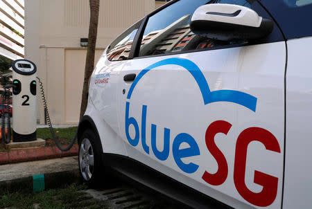 A BlueSG electric car-sharing vehicle is parked at a charging station in a public housing estate in Singapore December 12, 2017. REUTERS/Edgar Su