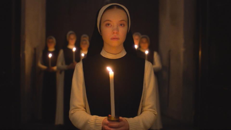 Sydney Sweeney in Immaculate holding a candle.