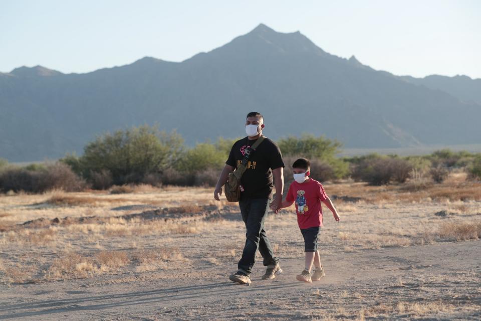 Charlie Aragon, 35, takes a walk with his son, Charles, 5, near his home in Laveen as part of his recovery from COVID-19  July 1, 2020. He was hospitalized on a ventilator and close to death after catching the disease in March.