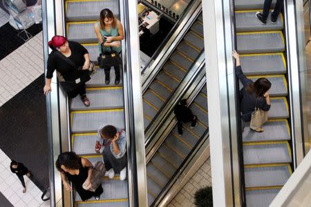Shoppers ride escalators at the Beverly Center mall in Los Angeles, California November 8, 2013. REUTERS/David McNew/File Photo