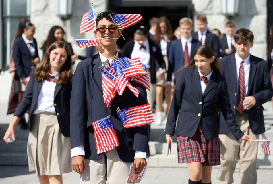 Logan Costa carries an abundance of American flags while leaving the Constitution Month kickoff event at the Capitol in Salt Lake City on Thursday, Aug. 31, 2023. | Kristin Murphy, Deseret News