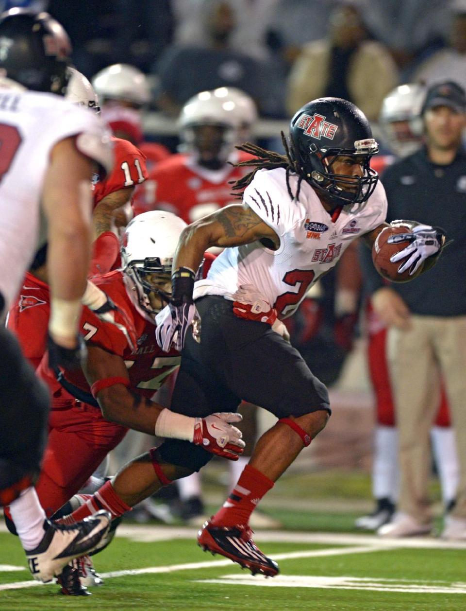 Arkansas State wide receiver J.D. McKissic (23) is tackled by Ball State linebacker Kenneth Lee (17) in the first quarter of the GoDaddy Bowl NCAA college football game in Mobile, Ala., Sunday, Jan. 5, 2014. (AP Photo/G.M. Andrews)