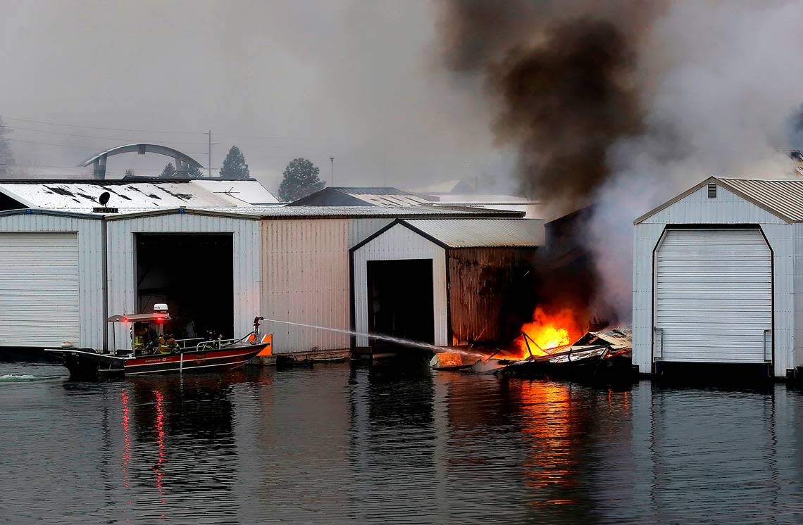 Frefighters in the Pasco Fire Department fire boat work to stop the spread of a boat house fire early Wednesday morning at the Clover Island Yacht Club in downtown Kennewick.