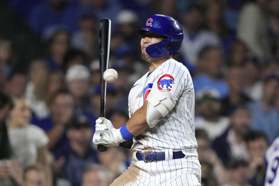 Chicago Cubs' Seiya Suzuki turns his head away from a high, inside pitch from Milwaukee Brewers starter Corbin Burnes during the sixth inning of a baseball game Tuesday, Aug. 29, 2023, in Chicago. (AP Photo/Charles Rex Arbogast)