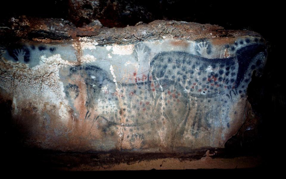 A pair of wild horses and other marks created on a rock surface in Pech-Merle Cave in France around 30,000 years ago