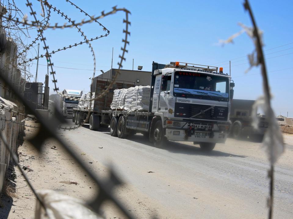Trucks full of goods depart from the Palestinian side of the Kerem Shalom cargo crossing with Israel in Rafah, southern Gaza Strip, on Wednesday: AP