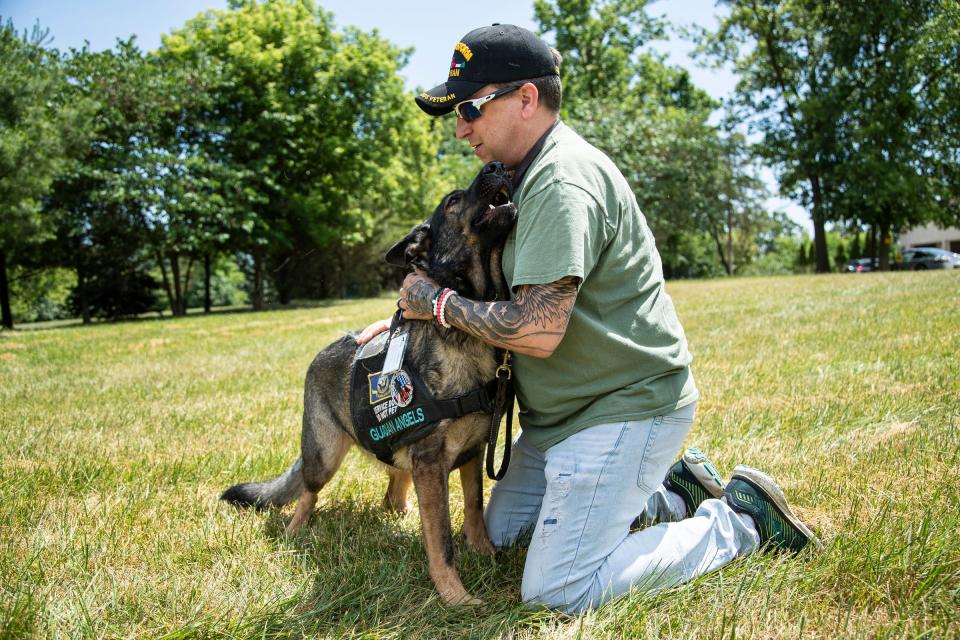 Navy veteran Sheldon Ewers of Jackson with his Guardian Angel service dog Patsy in Ann Arbor on June 30, 2022.