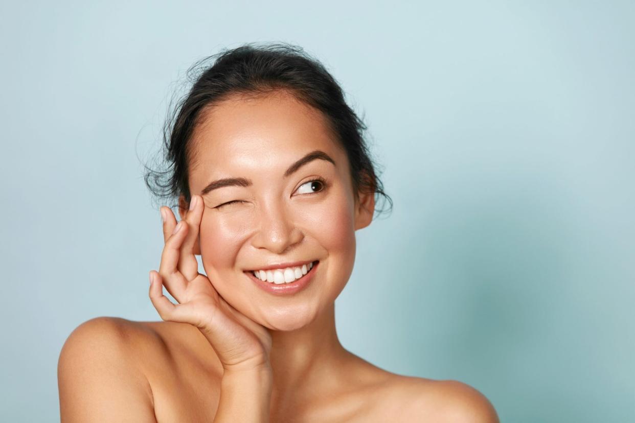 Woman with Beautiful Skin One Eye Closed Smiling