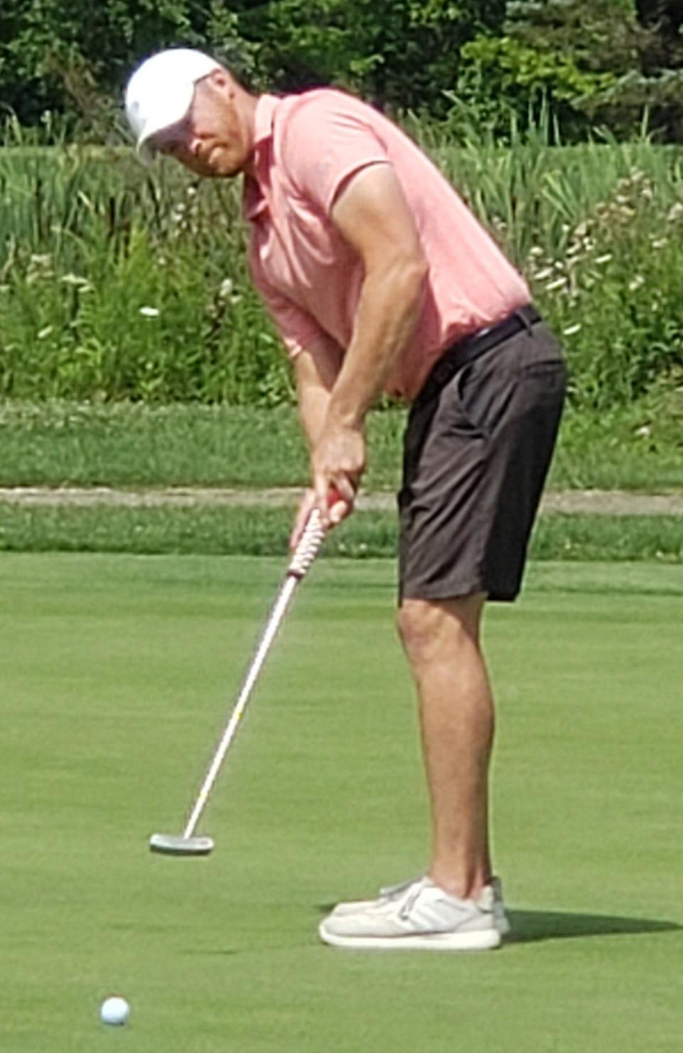 Jarrod Page sinks his final putt on the 18th hole at Raccoon Hill to secure the County Division championship of the Portage County Amateur.