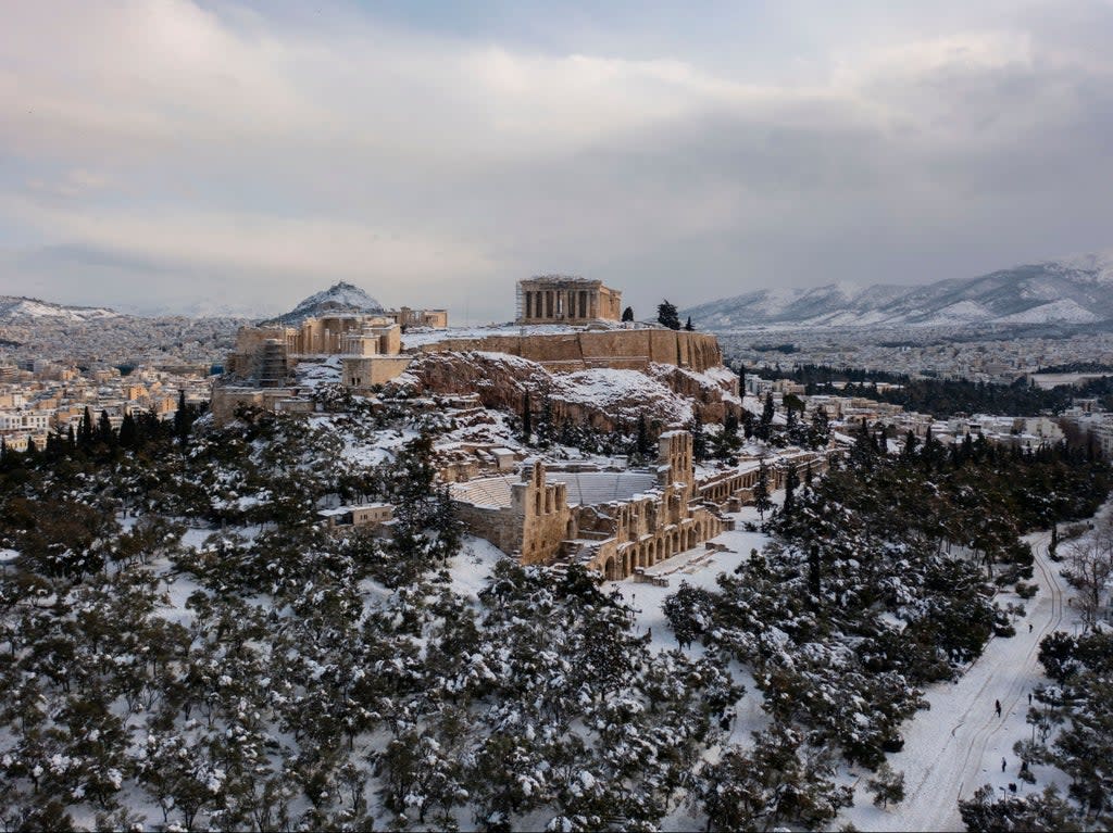 The snow covered Ancient Temple of Parthenon atop the Acropolis hill  (AFP via Getty Images)