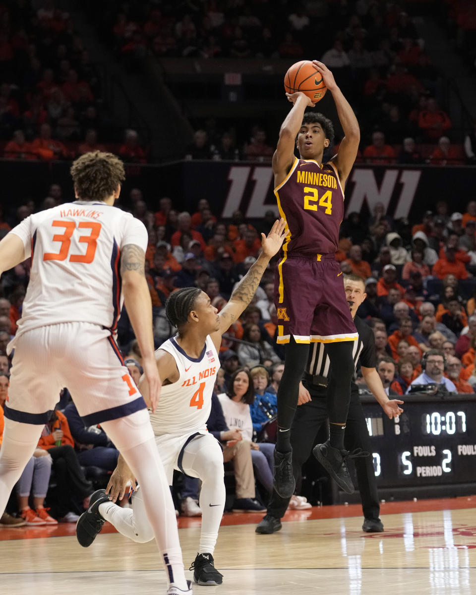 Minnesota's Cam Christie (24) shoots over Illinois' Justin Harmon as Coleman Hawkins watches during the second half of an NCAA college basketball game Wednesday, Feb. 28, 2024, in Champaign, Ill. Illinois won 105-97. (AP Photo/Charles Rex Arbogast)
