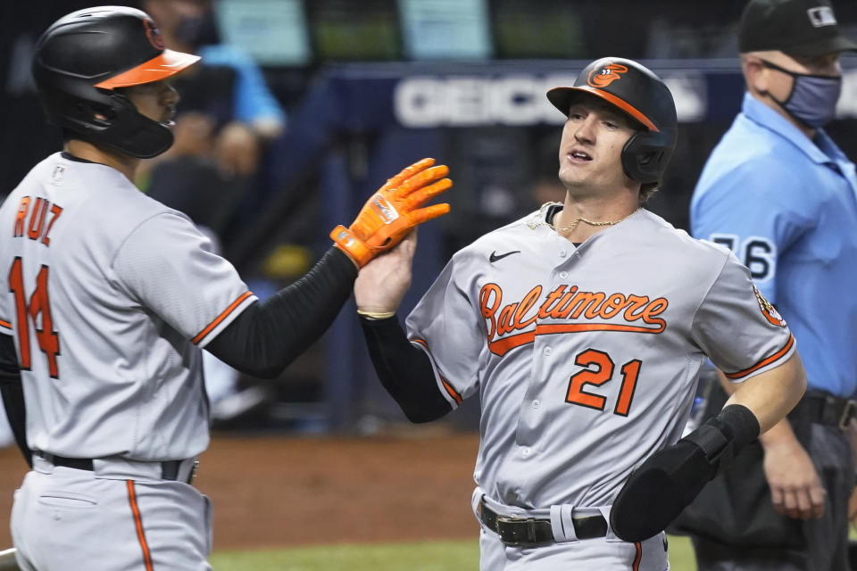 Baltimore Orioles' Rio Ruiz (14) congratulates Austin Hayes (21) after Hayes scores a run during the first inning of a baseball game against the Miami Marlins, Tuesday, April 20, 2021, in Miami. (AP Photo/Marta Lavandier)