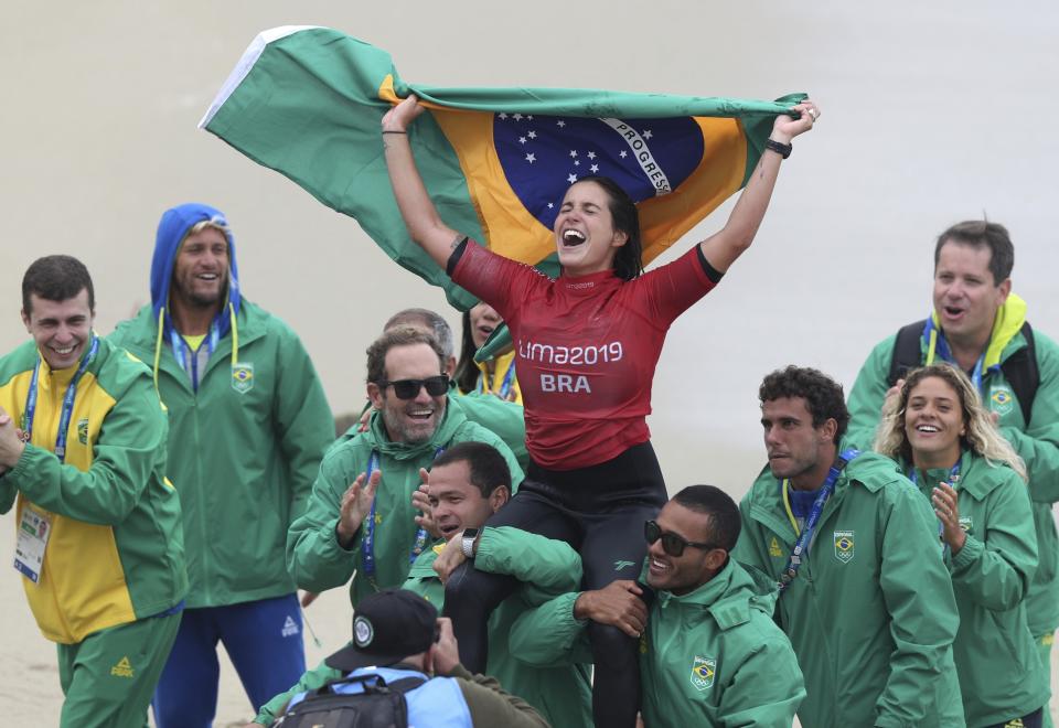 Chloe Calmon of Brazil celebrates wining the gold for longboard in the women's SUP surfing final at the Pan American Games on Punta Rocas beach in Lima Peru, Sunday, Aug. 4, 2019. (AP Photo/Martin Mejia)