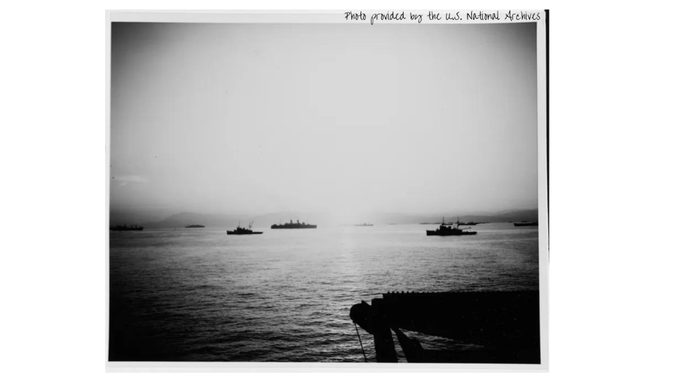 Sunrise over Salerno Bay, 10 September 1943, showing a portion of the invasion fleet. Two U.S. Navy fleet tugs are among the nearer ships.