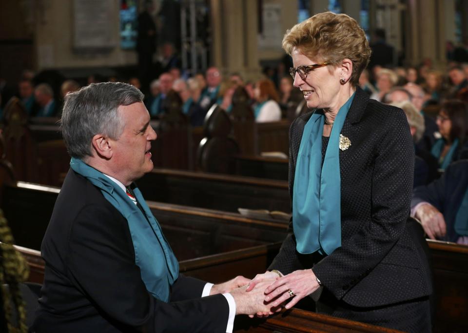 Ontario Premier Kathleen Wynne shakes hands with Ontario's Lieutenant Governor David Onley before the state funeral for Canada's former finance minister Jim Flaherty in Toronto