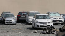 <p>A picture taken on August 4, 2017 shows parked cars damaged by the fire that hit “The Torch”, one of the tallest towers in Dubai, early in the morning. (Photo: Karim Sahib/AFP/Getty Images) </p>