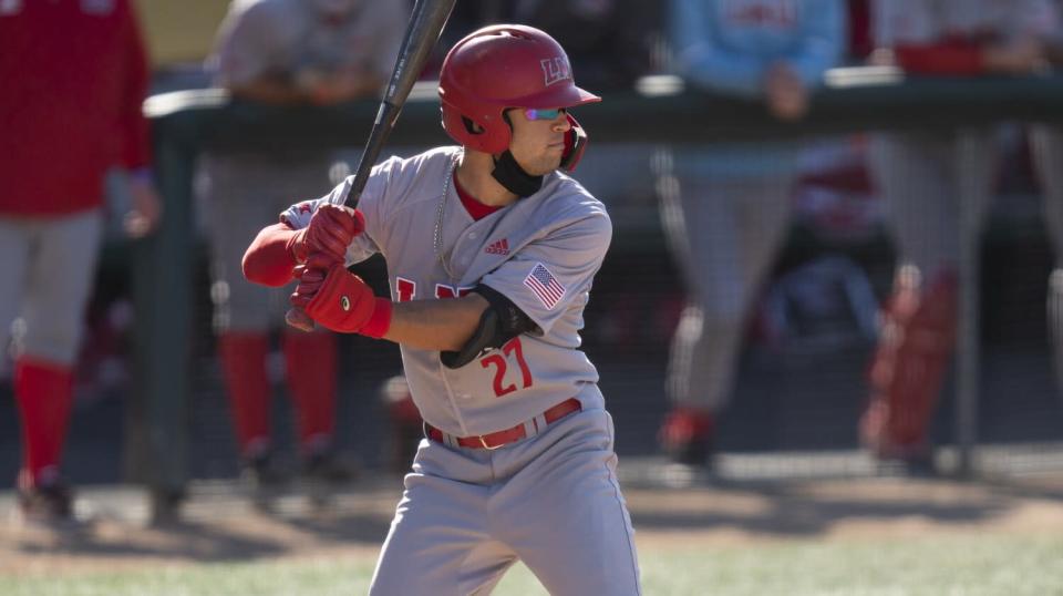 A right-handed batter stands at the plate, ready for a pitch